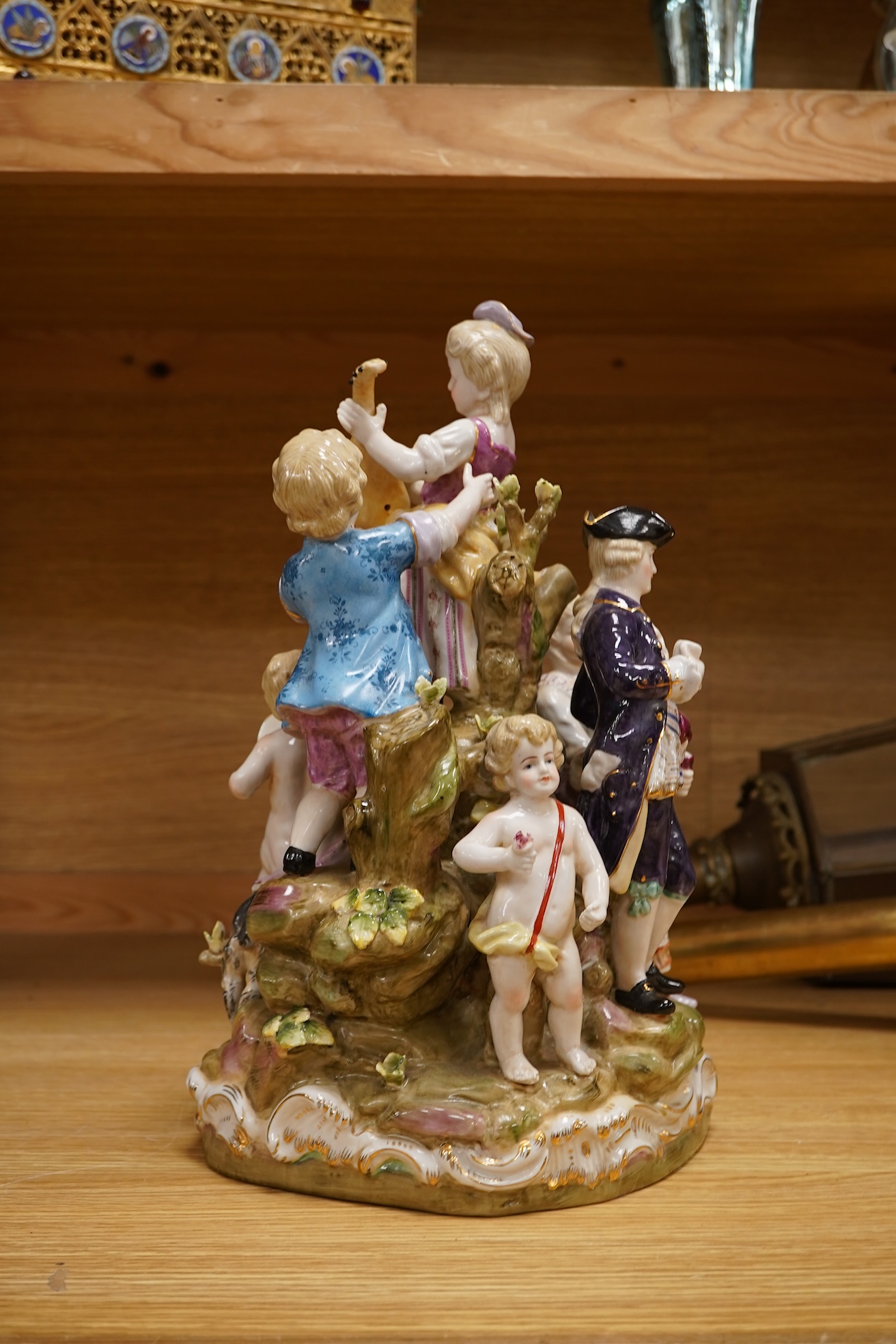A large German porcelain group, figures playing instruments, 35cm high